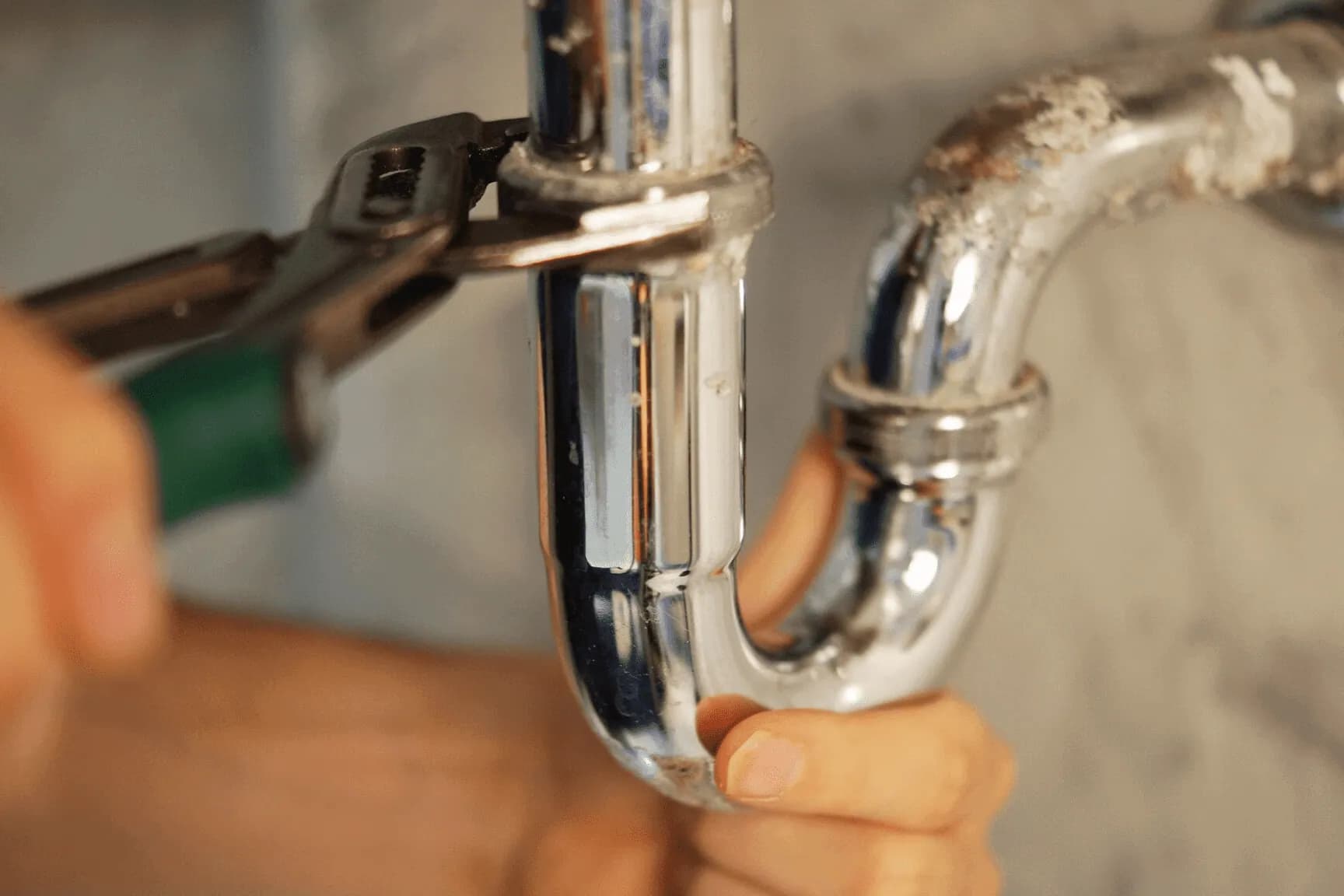 Close up of a Hamilton plumber fixing a clogged drain