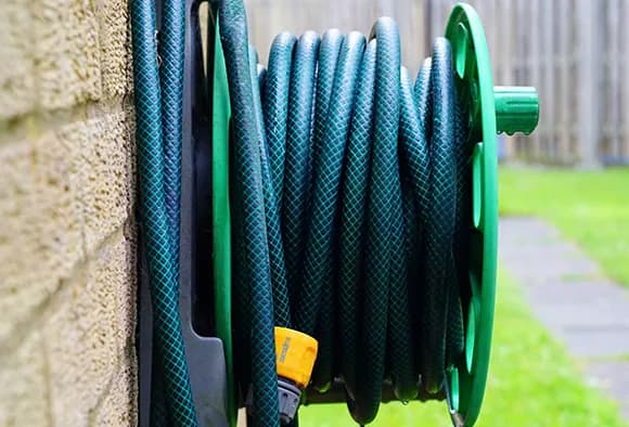 A hose bib with the hose attached to it