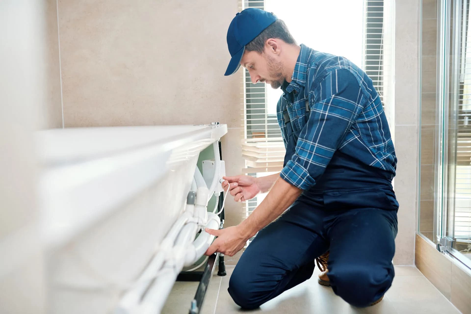 A plumbing expert installing a bathtub