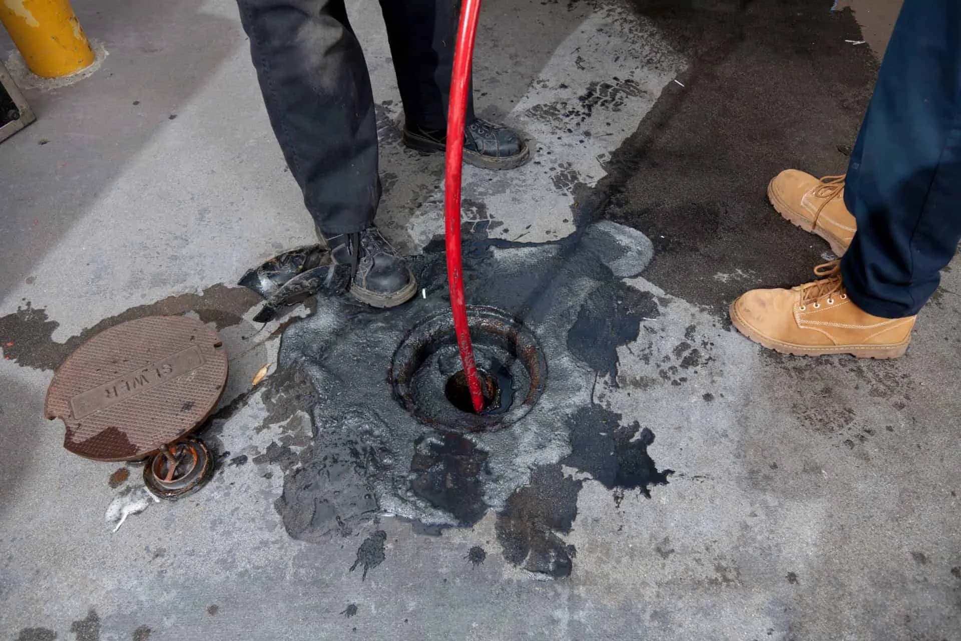 A plumber unclogging a drain