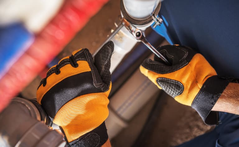 A man using adjustable pipe clamps