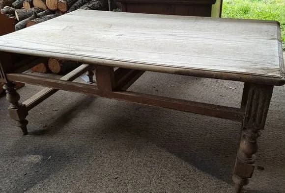Water-damaged furniture showing a white discoloration on its finish
