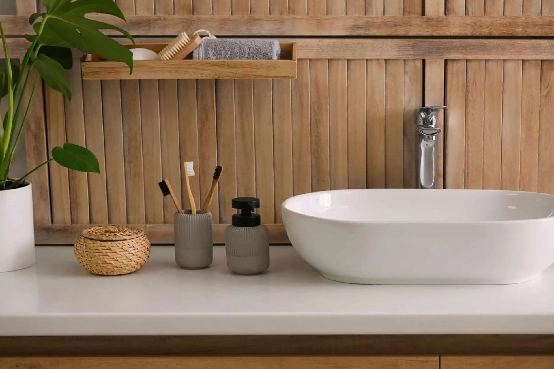 White bathroom countertop with a wooden backsplash