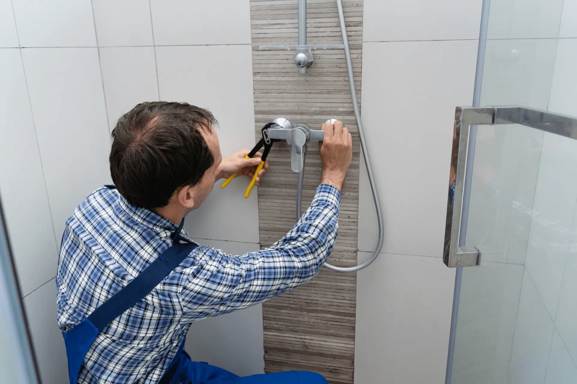A plumber installing a shower