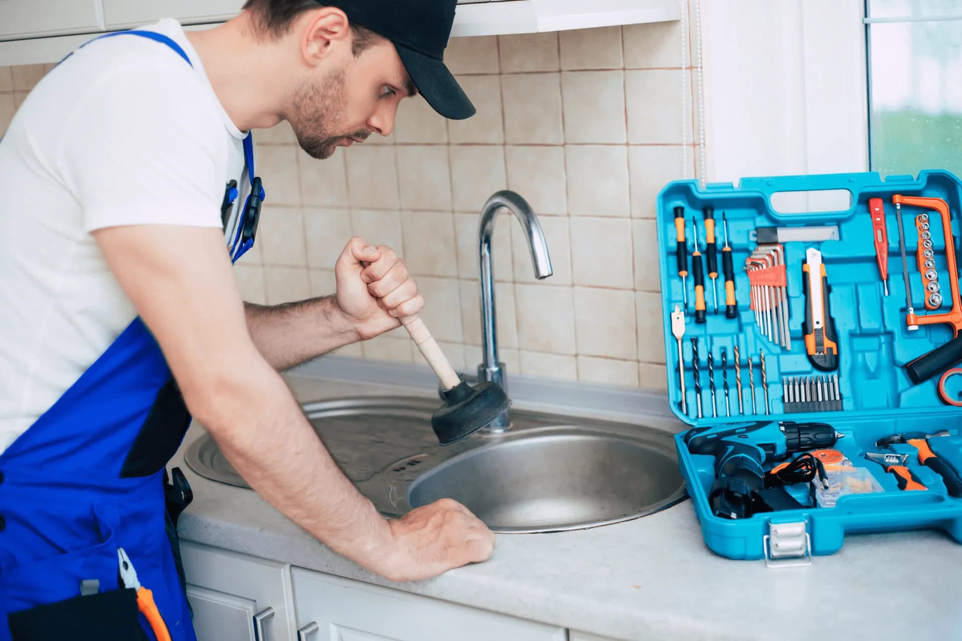 A plumber repairing a slow drain