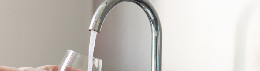 Water from the tap running into a clear glass